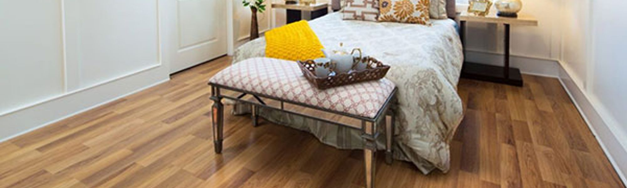 bed in a room on top of hardwood flooring