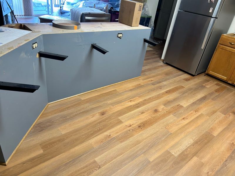 new hardwood flooring in a new construction kitchen