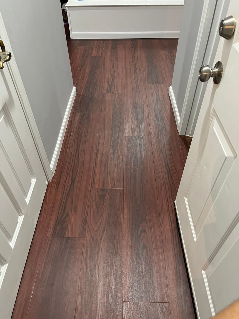 dark red vinyl flooring in a narrow hallway