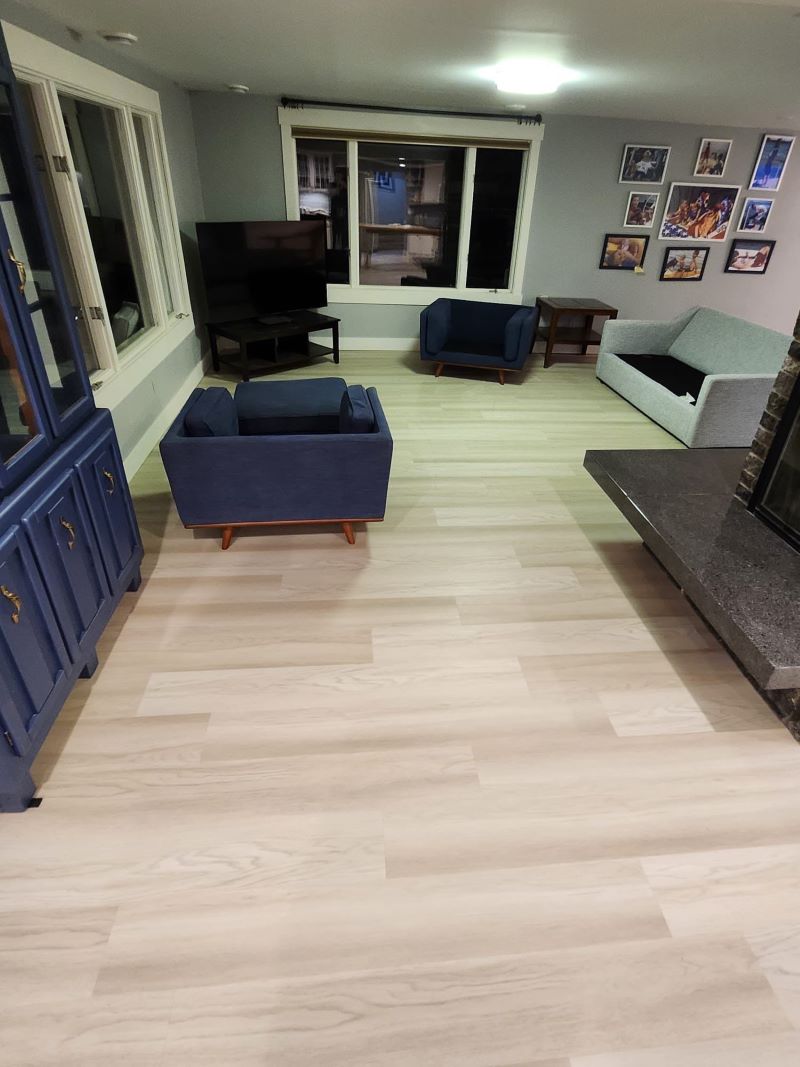 light laminate flooring in a living area with furniture