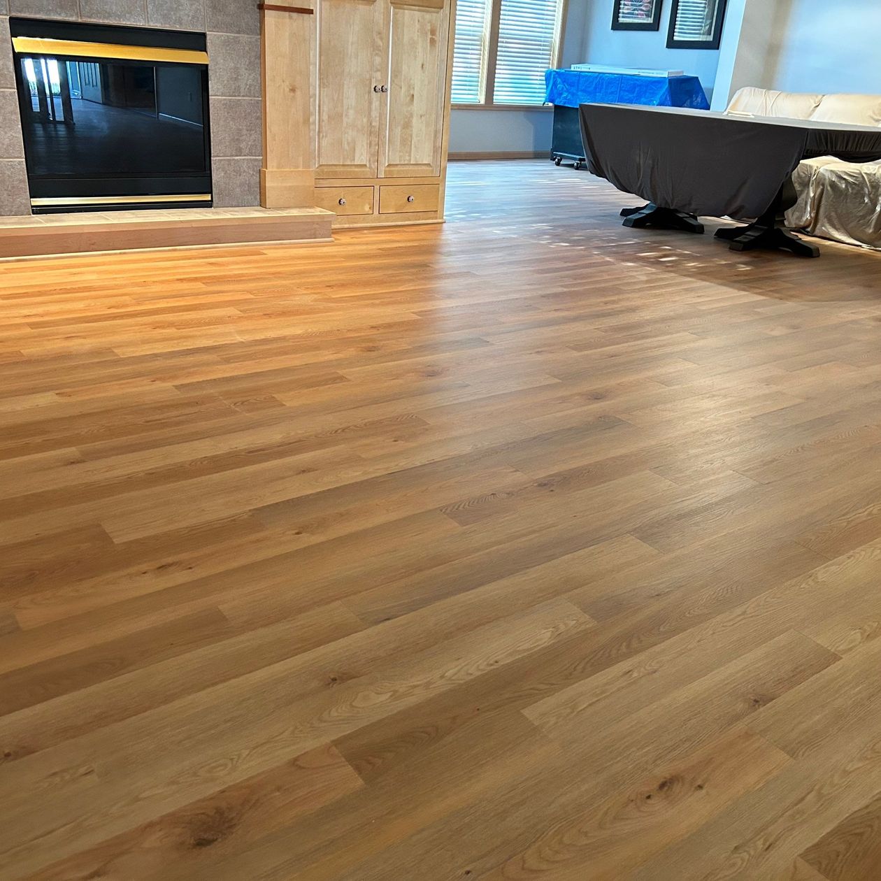 worker cleaning a wooden floor