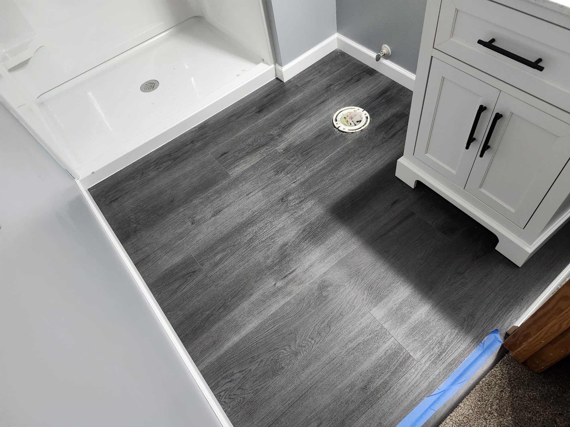 bathroom with dark grey vinyl flooring