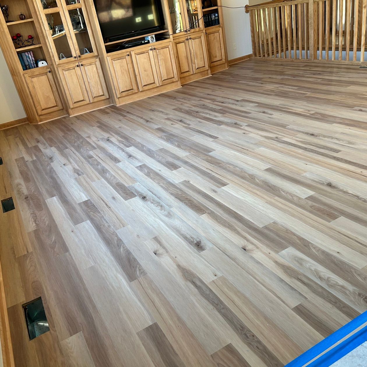 worker cleaning a wooden floor